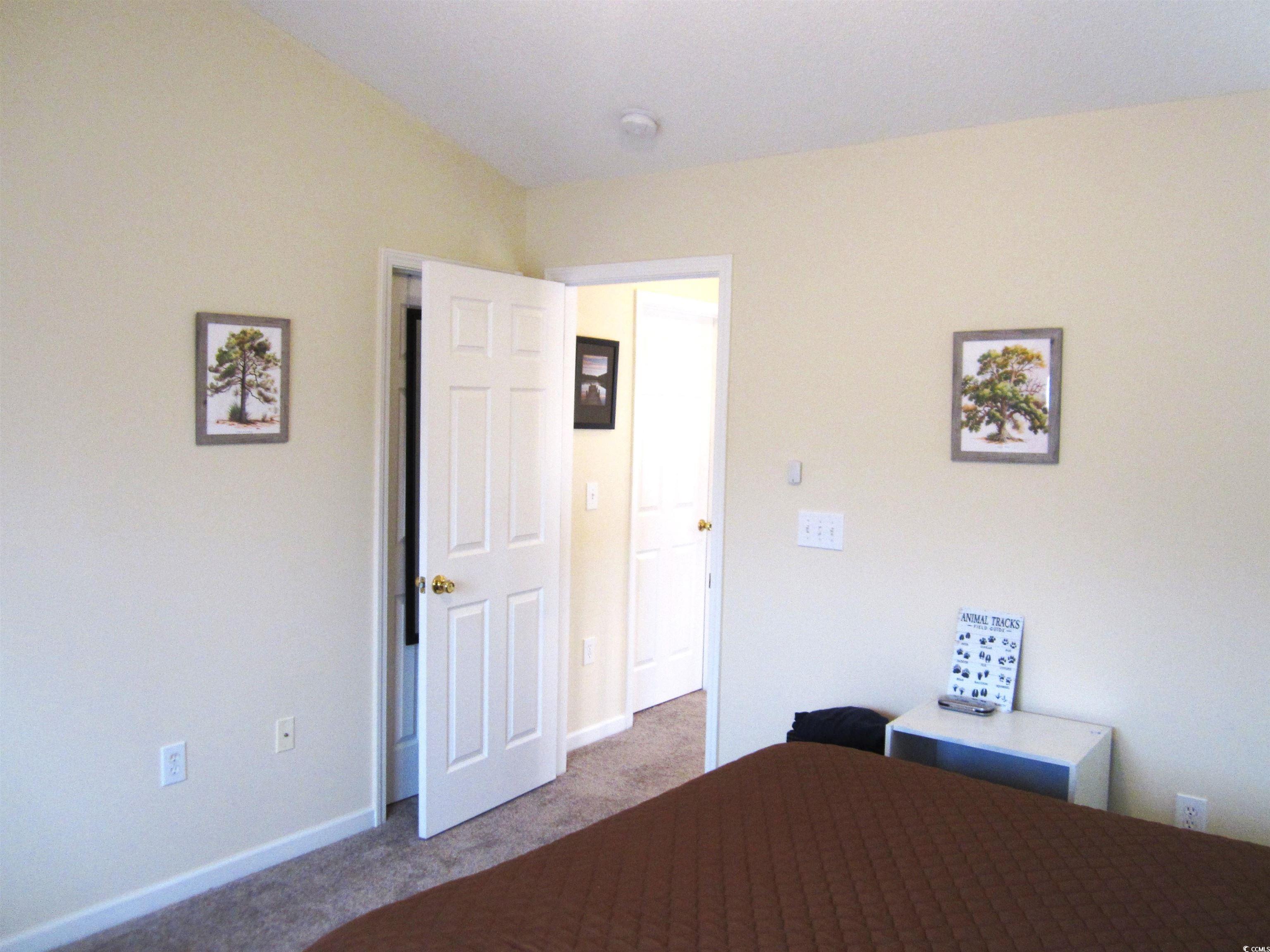 1071 Pinwheel Loop, Unit 1071 Myrtle Beach, SC 29577 - Photo 23 of 39 Unfurnished bedroom with carpet and vaulted ceilin