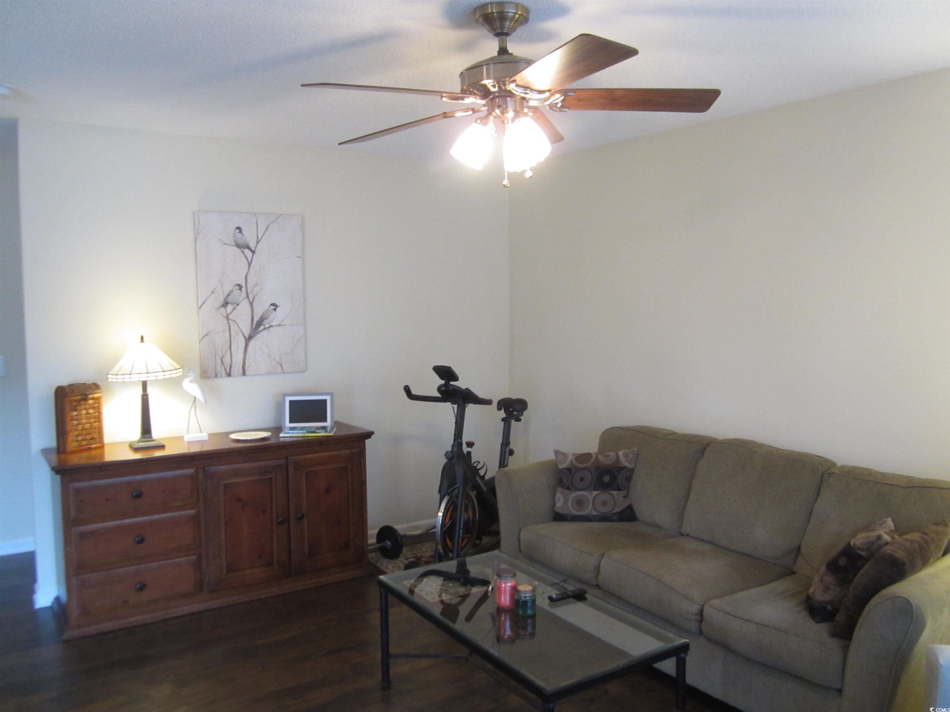 1071 Pinwheel Loop, Unit 1071 Myrtle Beach, SC 29577 - Photo 6 of 39 Living room with ceiling fan and dark hardwood / w