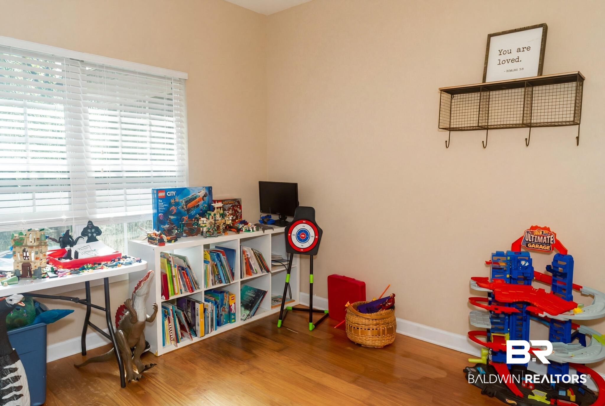 8008 Patricks Landing Road Bay Minette, AL 36507 - Photo 15 of 33 Room featuring a large window with horizontal blinds, wood-finish flooring, and light-toned walls