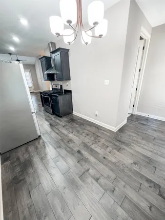 a view of a room with wooden floor