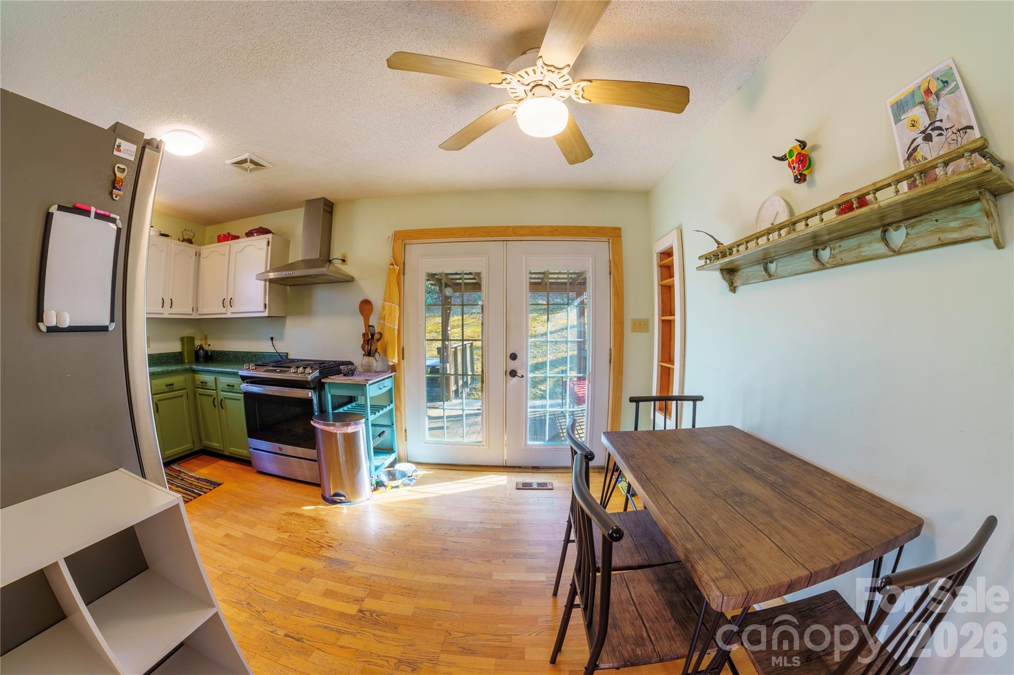 84 Forest Trail Balsam Grove, NC 28708 - Photo 16 of 45 a kitchen with a table chairs refrigerator and cabinets