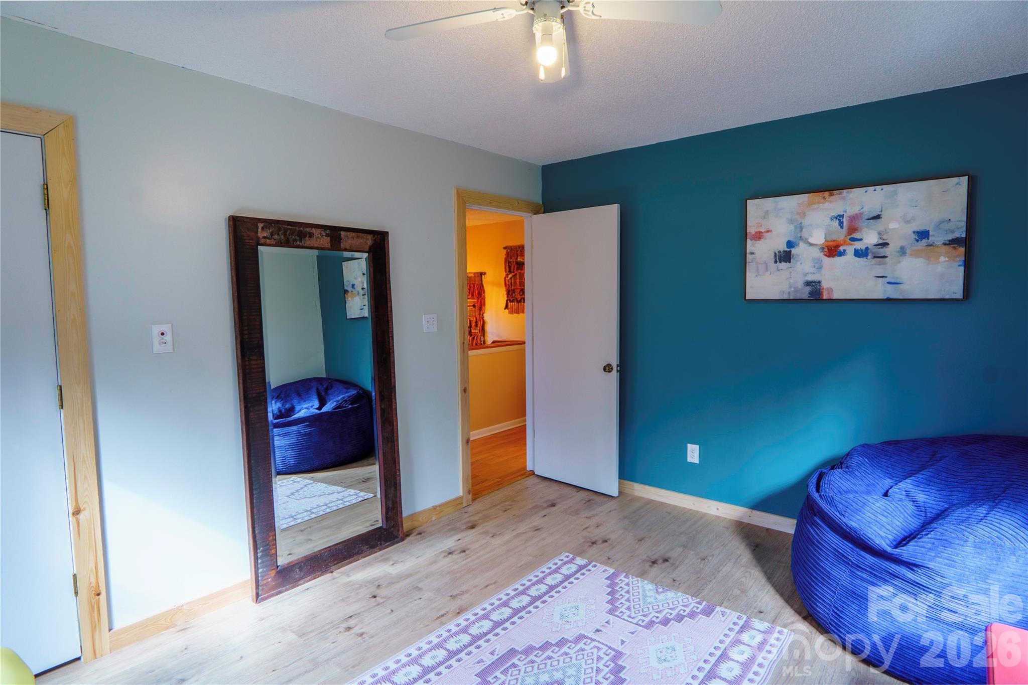 84 Forest Trail Balsam Grove, NC 28708 - Photo 27 of 45 a view of a bedroom with a bed and a chandelier