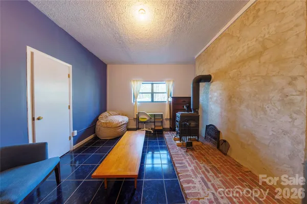 a spacious bedroom with a bed and wooden floor