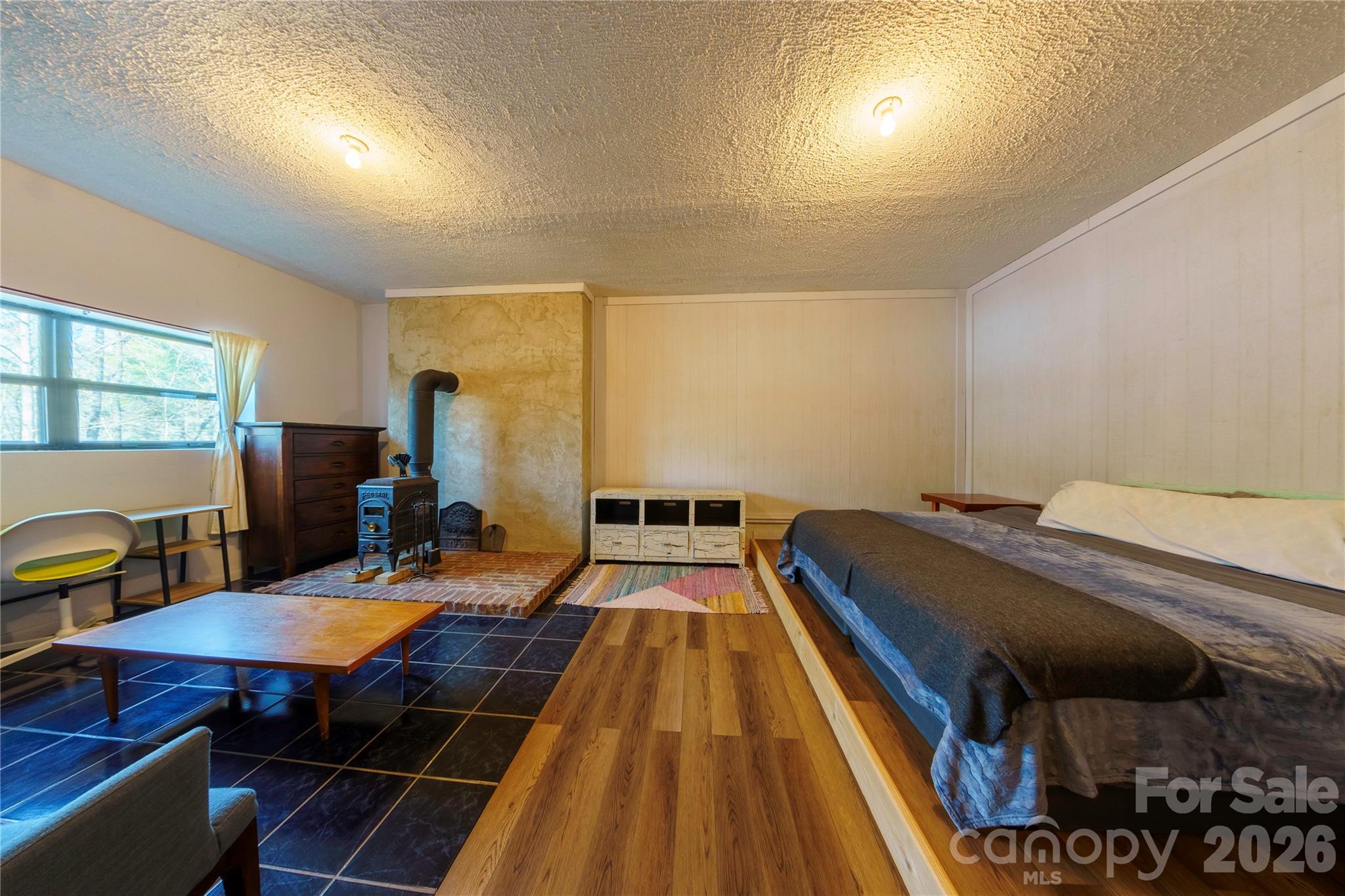 84 Forest Trail Balsam Grove, NC 28708 - Photo 35 of 45 a bedroom with a bed and wooden floor