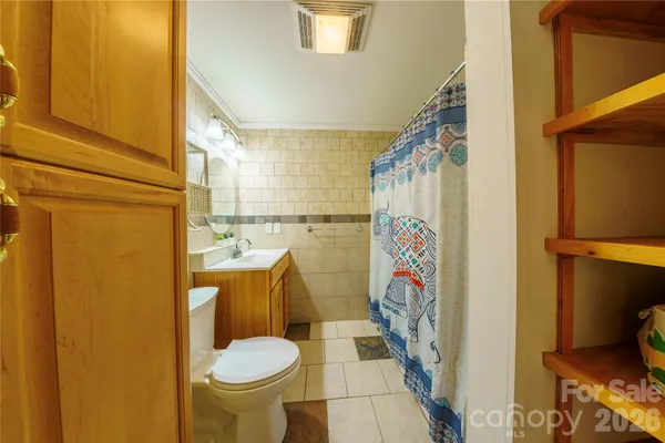 a bathroom with a toilet and a shower curtain