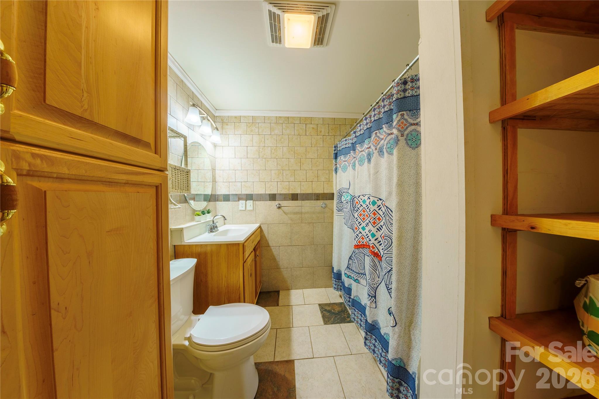 84 Forest Trail Balsam Grove, NC 28708 - Photo 37 of 45 a bathroom with a toilet and a shower curtain