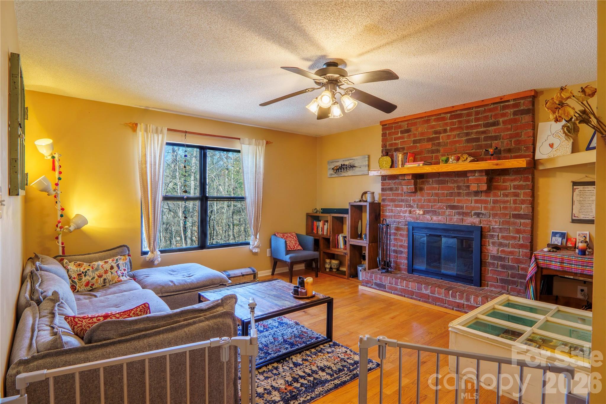 84 Forest Trail Balsam Grove, NC 28708 - Photo 8 of 45 a living room with furniture a fireplace and a flat screen tv