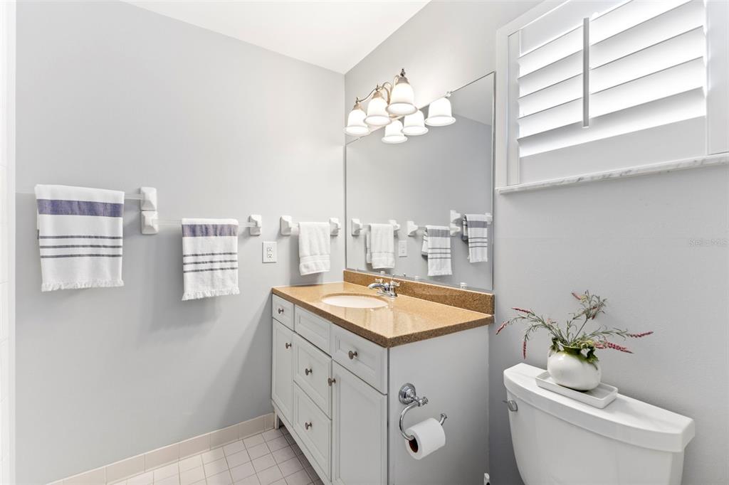 3978 Overlook Bend Terrace, Unit 25 Sarasota, FL 34232 - Photo 11 of 18 a bathroom with a sink a toilet and a mirror