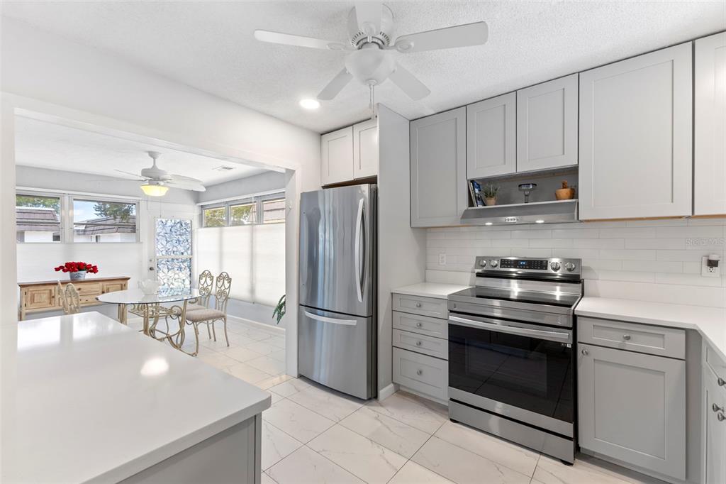 3978 Overlook Bend Terrace, Unit 25 Sarasota, FL 34232 - Photo 2 of 18 a kitchen with stainless steel appliances a stove a refrigerator and a refrigerator