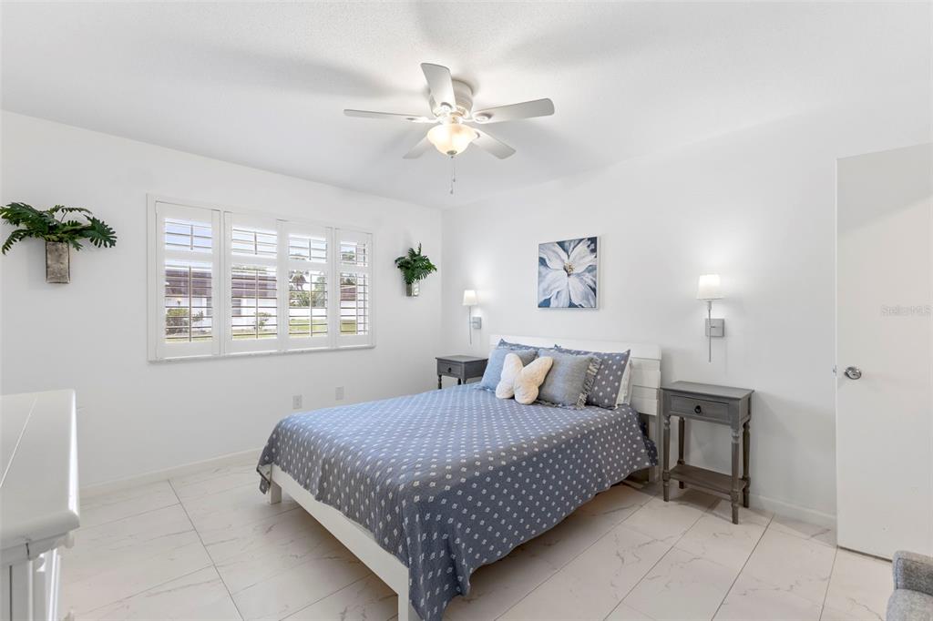 3978 Overlook Bend Terrace, Unit 25 Sarasota, FL 34232 - Photo 5 of 18 a bedroom with a large bed and a window