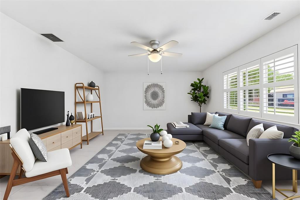 3978 Overlook Bend Terrace, Unit 25 Sarasota, FL 34232 - Photo 6 of 18 a living room with furniture a chandelier and a flat screen tv
