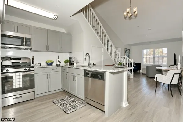 a kitchen with a stove and white cabinets