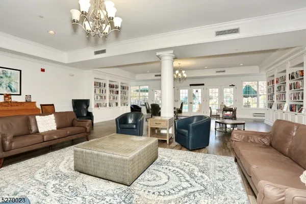 a living room with furniture or chandelier and a wooden floor