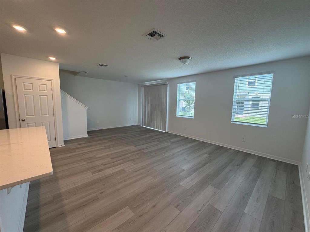 4264 Ranch House Road St. Cloud, FL 34772 - Photo 8 of 34 a view of an empty room with wooden floor and a window