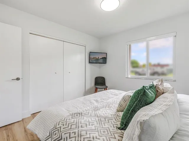 a bedroom with a bed and a window