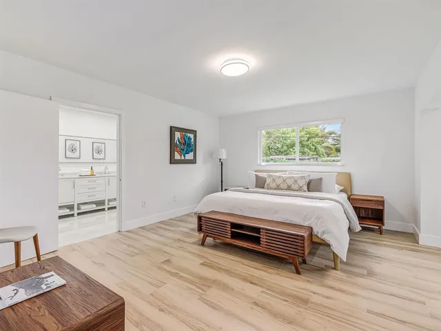 a bedroom with a bed and a table in it