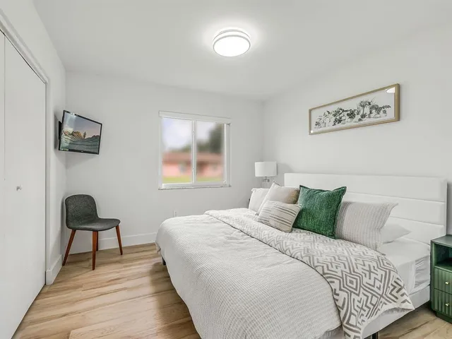 a bedroom with a bed and a chair