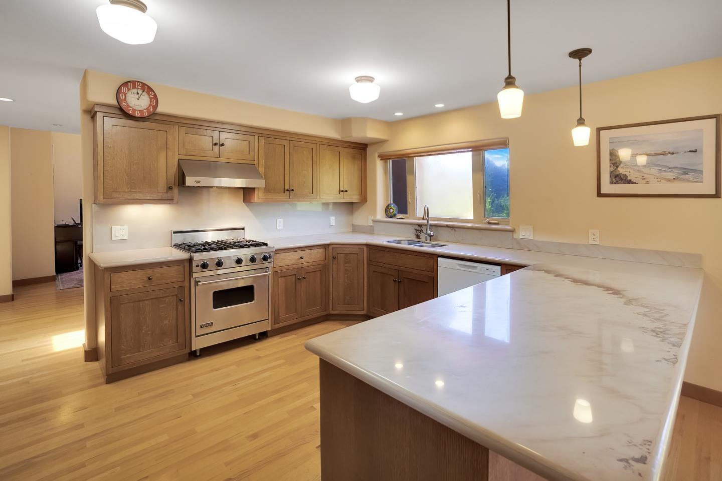 151 Rancho Road Watsonville, CA 95076 - Photo 11 of 56 a kitchen with stainless steel appliances granite countertop a sink a stove and a wooden floors
