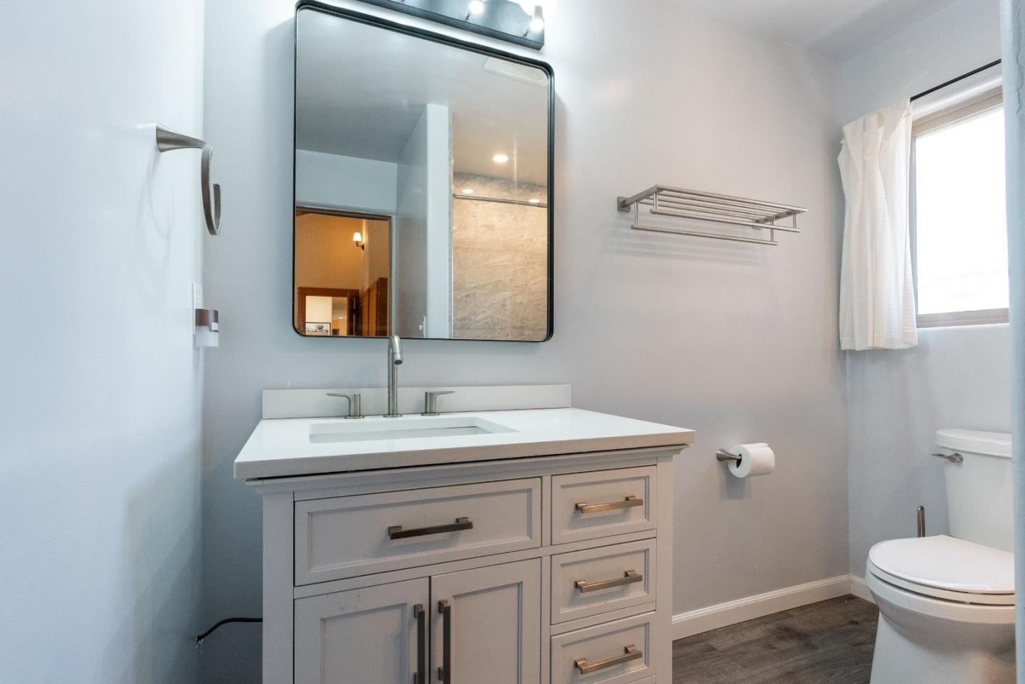 151 Rancho Road Watsonville, CA 95076 - Photo 14 of 56 a bathroom with a toilet sink and mirror