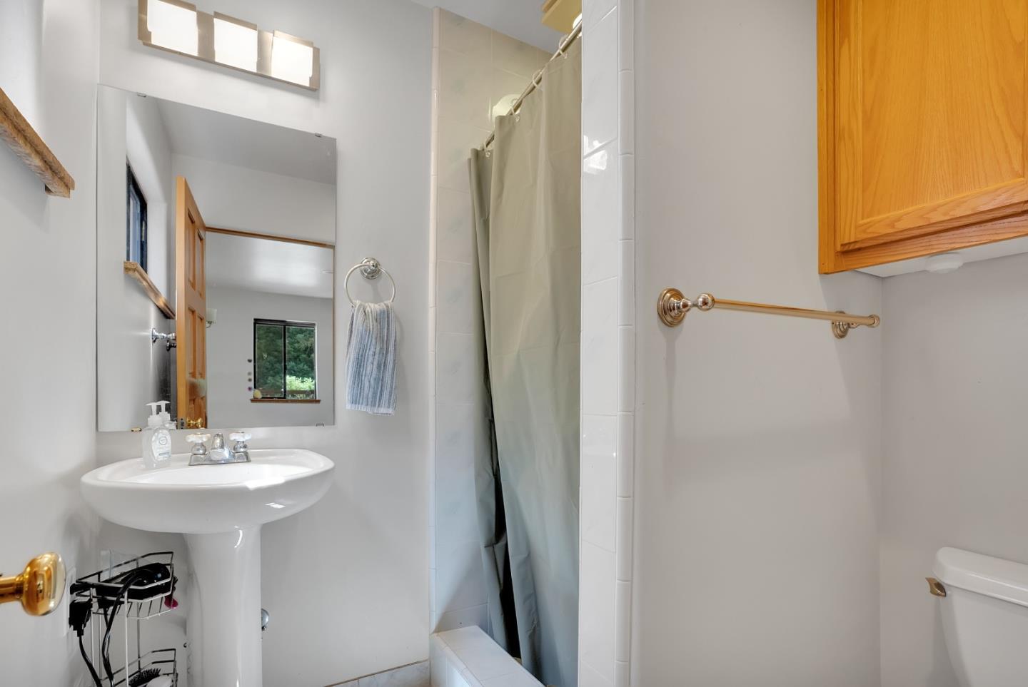 151 Rancho Road Watsonville, CA 95076 - Photo 33 of 56 a bathroom with a sink a mirror and a shower