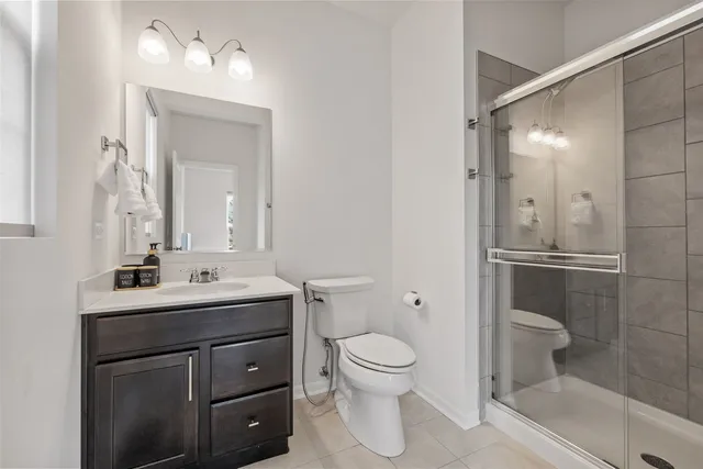 a bathroom with a toilet a sink and shower
