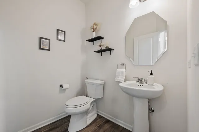 a bathroom with a sink a toilet and mirror