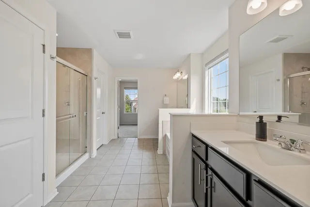 a bathroom with a sink double vanity and a mirror