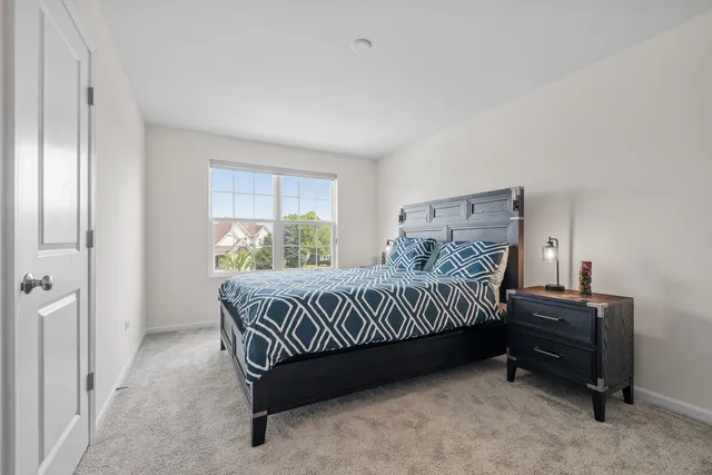 a bed sitting in a bedroom next to a window