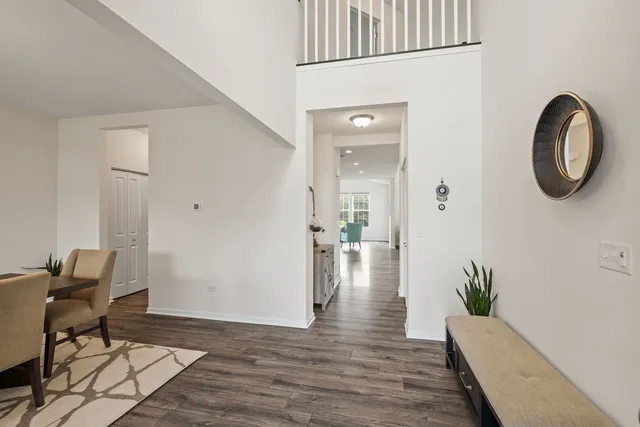 a view of a hallway with wooden floor and furniture