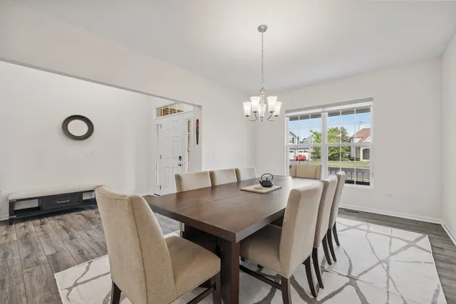 a view of a dining room with furniture and chandelier
