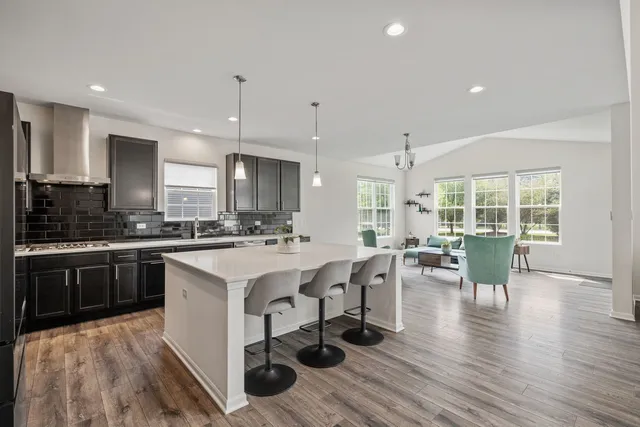 a large kitchen with a table and chairs