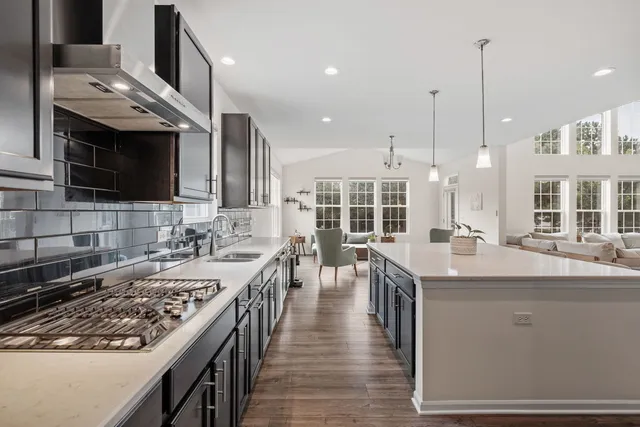 a kitchen with lots of counter top space a sink appliances and cabinets