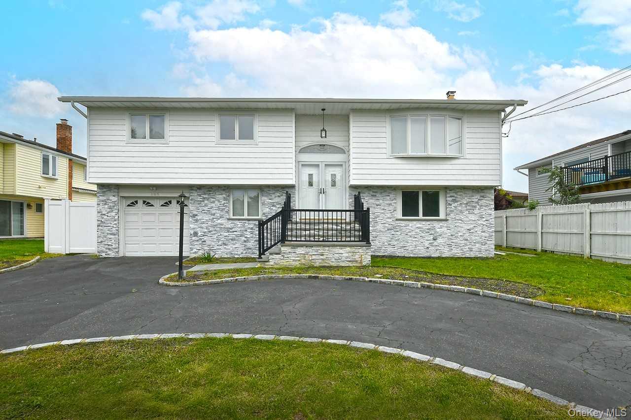 107 Beverly Road Massapequa, NY 11758 - Photo 1 of 41 a front view of a house with garden