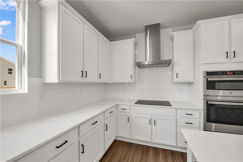 660 Devon Alley Acworth, GA 30102 - Photo 16 of 32 a kitchen with white cabinets and white appliances