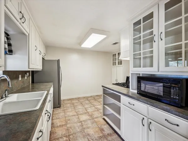 a kitchen with stainless steel appliances granite countertop a stove and a sink