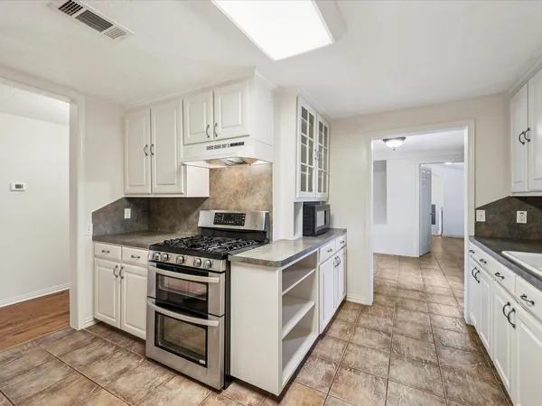 a kitchen with granite countertop cabinets and steel stainless steel appliances