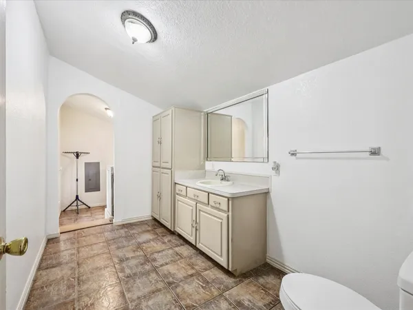 a bathroom with a sink a toilet and a mirror