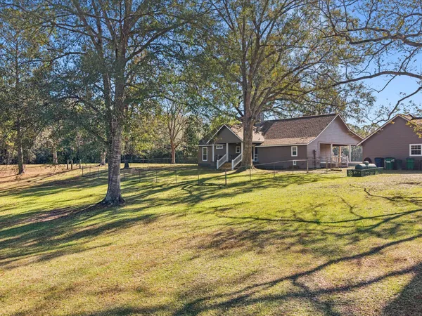 a view of a house with swimming pool next to a yard