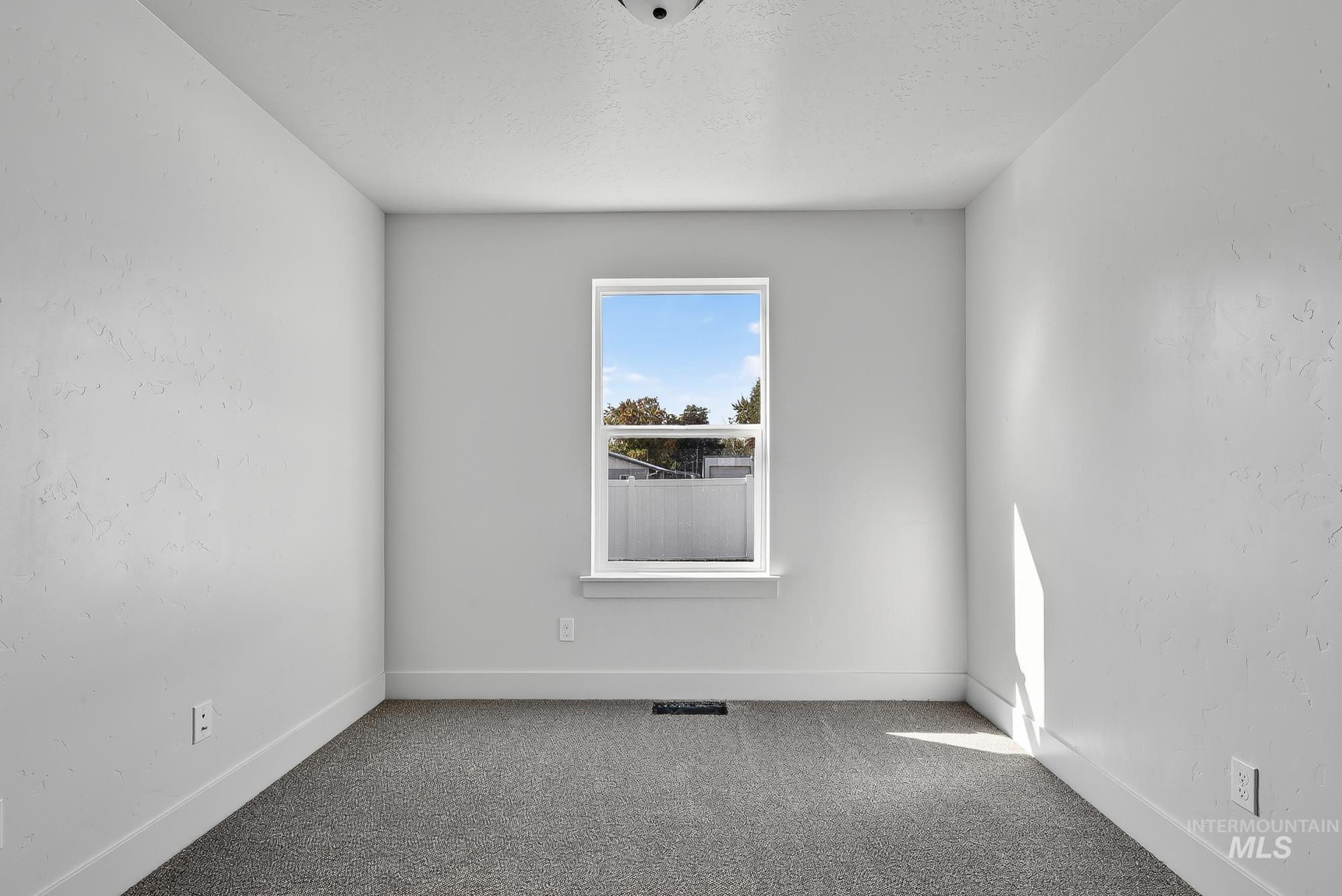 1158 Velvet Loop Wilder, ID 83676 - Photo 14 of 34 Carpeted spare room with baseboards and a textured ceiling
