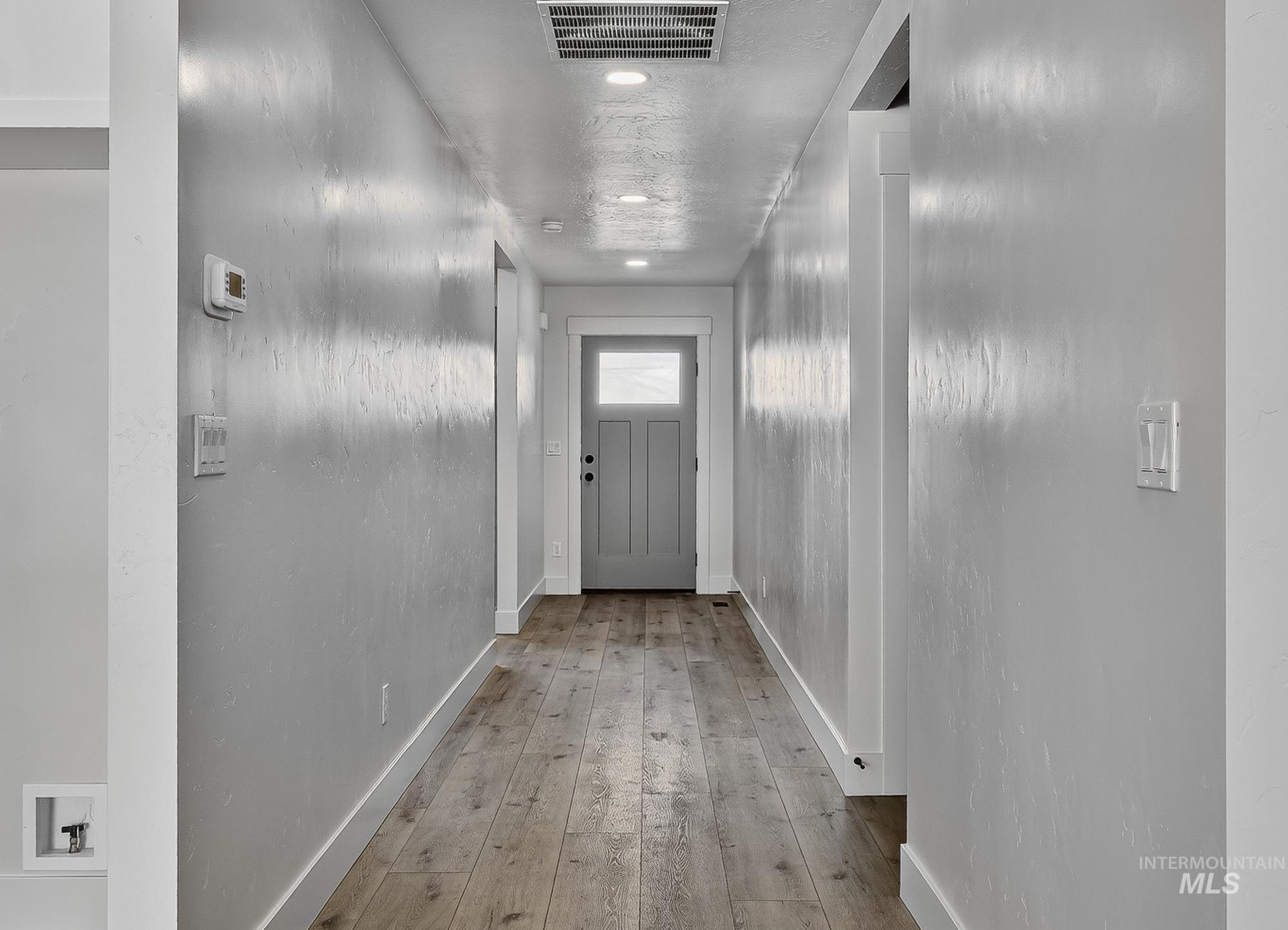 1158 Velvet Loop Wilder, ID 83676 - Photo 2 of 34 Doorway featuring baseboards and hardwood / wood-style floors