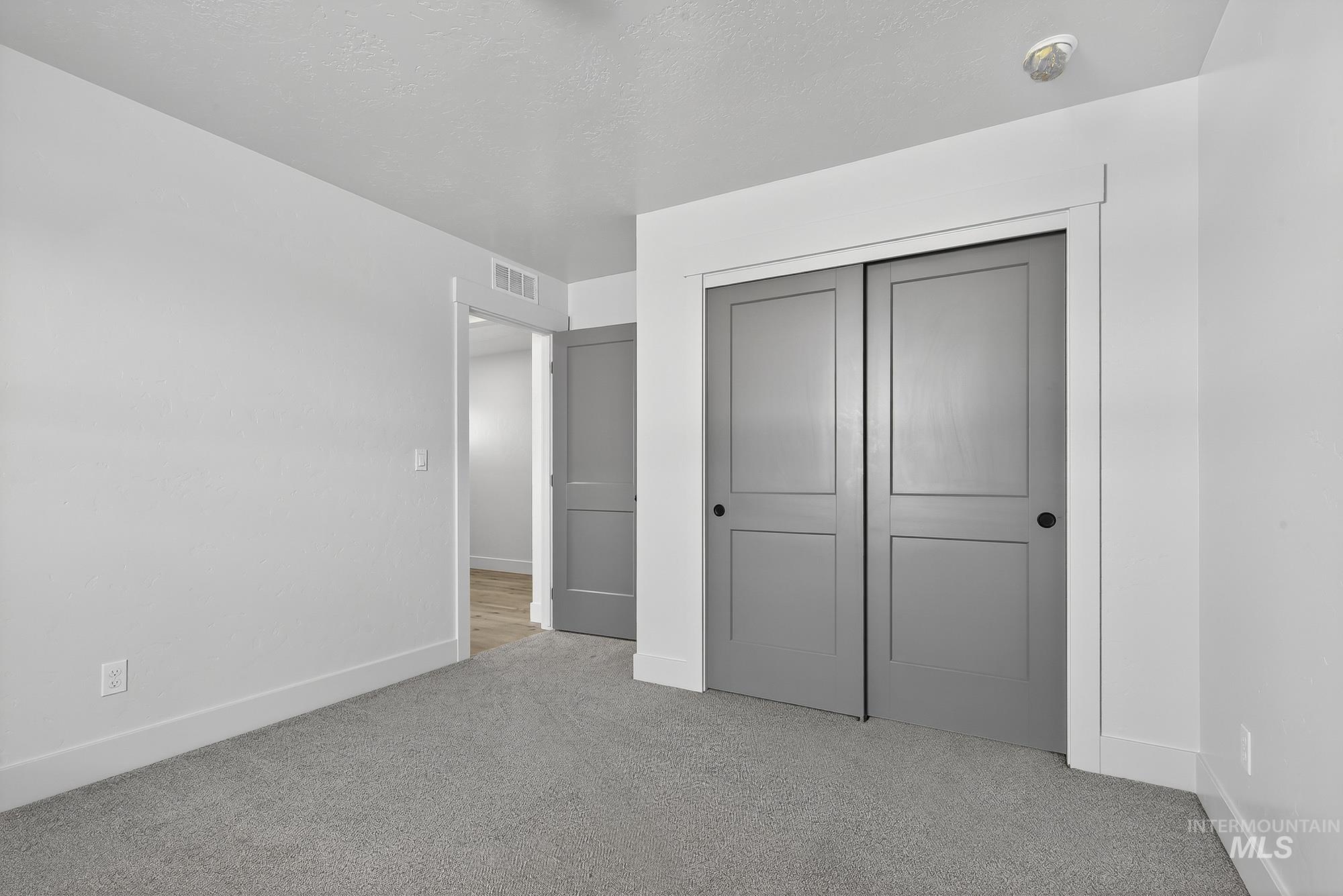 1158 Velvet Loop Wilder, ID 83676 - Photo 27 of 34 Unfurnished bedroom featuring light colored carpet and a closet