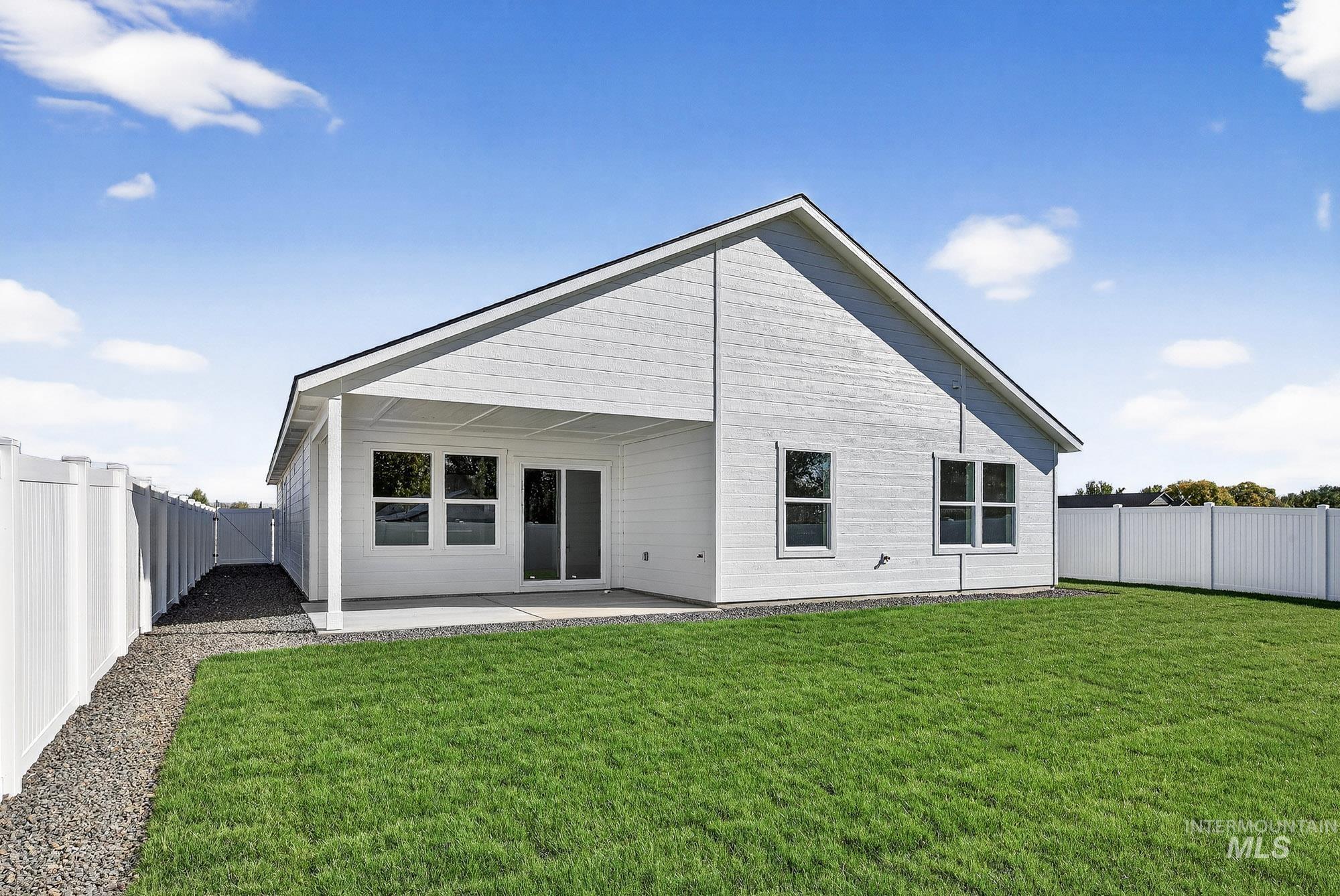 1158 Velvet Loop Wilder, ID 83676 - Photo 30 of 34 Rear view of house featuring a patio area and a fenced backyard