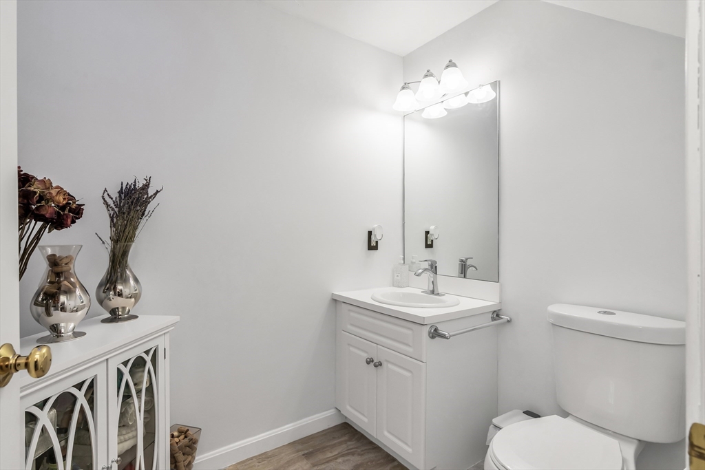 1 Riverview Boulevard, Unit 7204 Methuen, MA 01844 - Photo 12 of 29 a bathroom with a toilet sink and mirror