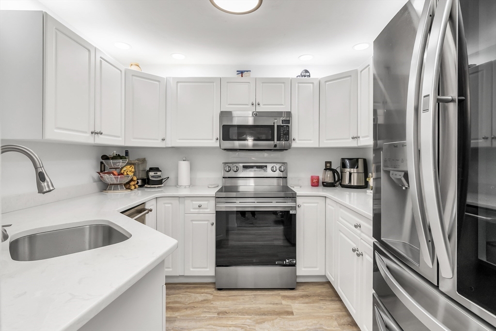 1 Riverview Boulevard, Unit 7204 Methuen, MA 01844 - Photo 14 of 29 a kitchen with a sink stove and refrigerator