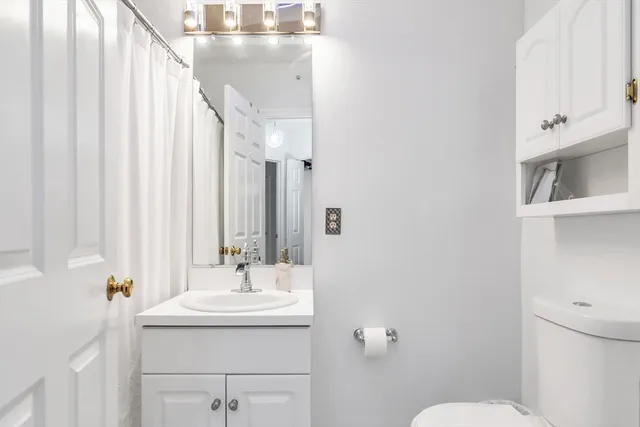 a bathroom with a sink a mirror and a toilet