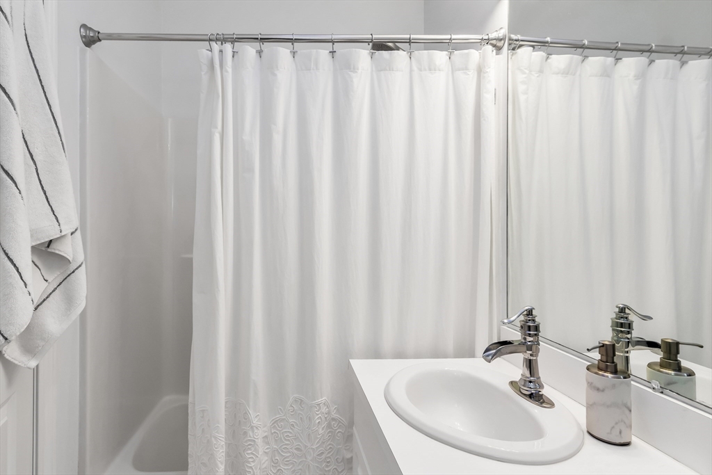 1 Riverview Boulevard, Unit 7204 Methuen, MA 01844 - Photo 21 of 29 a bathroom with a sink and a mirror