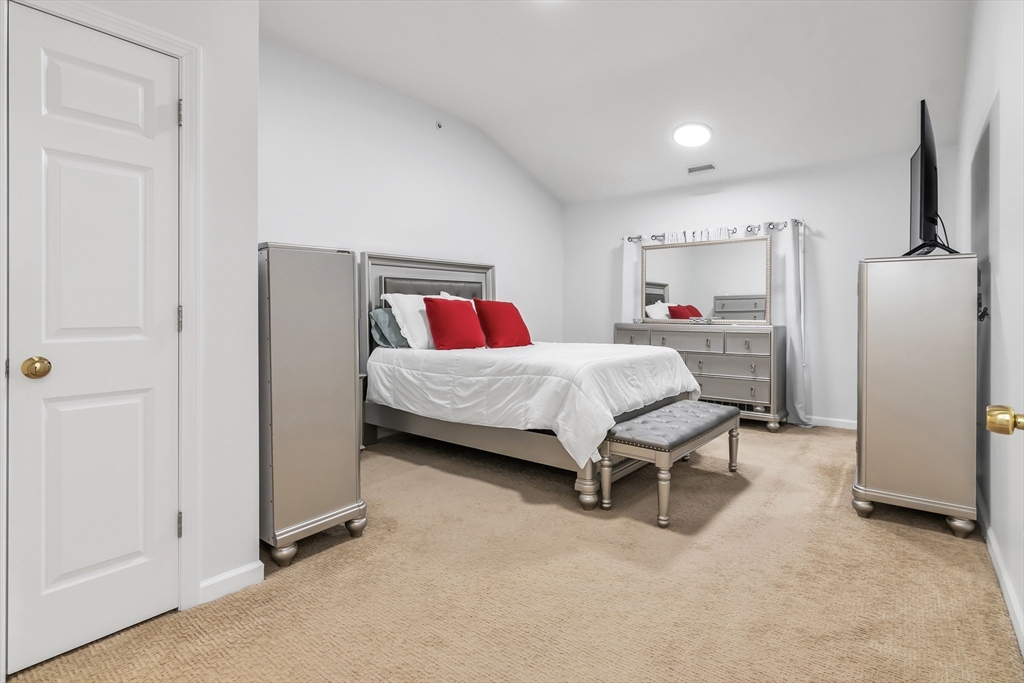 1 Riverview Boulevard, Unit 7204 Methuen, MA 01844 - Photo 22 of 29 a room with a bed and a table