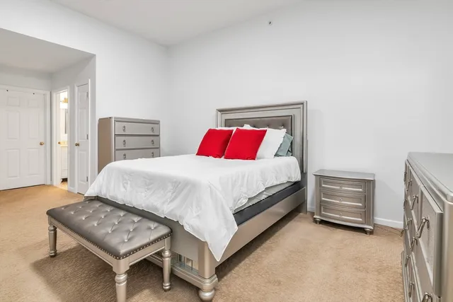 a bedroom with a bed and dresser