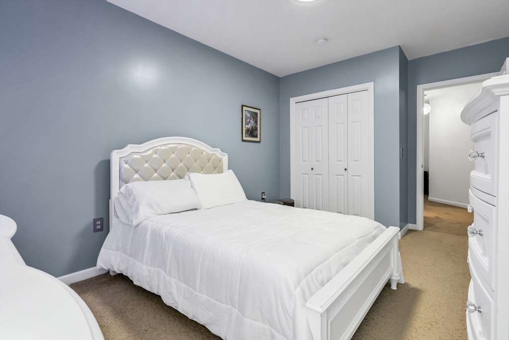 1 Riverview Boulevard, Unit 7204 Methuen, MA 01844 - Photo 27 of 29 a bedroom with a bed and a lamp
