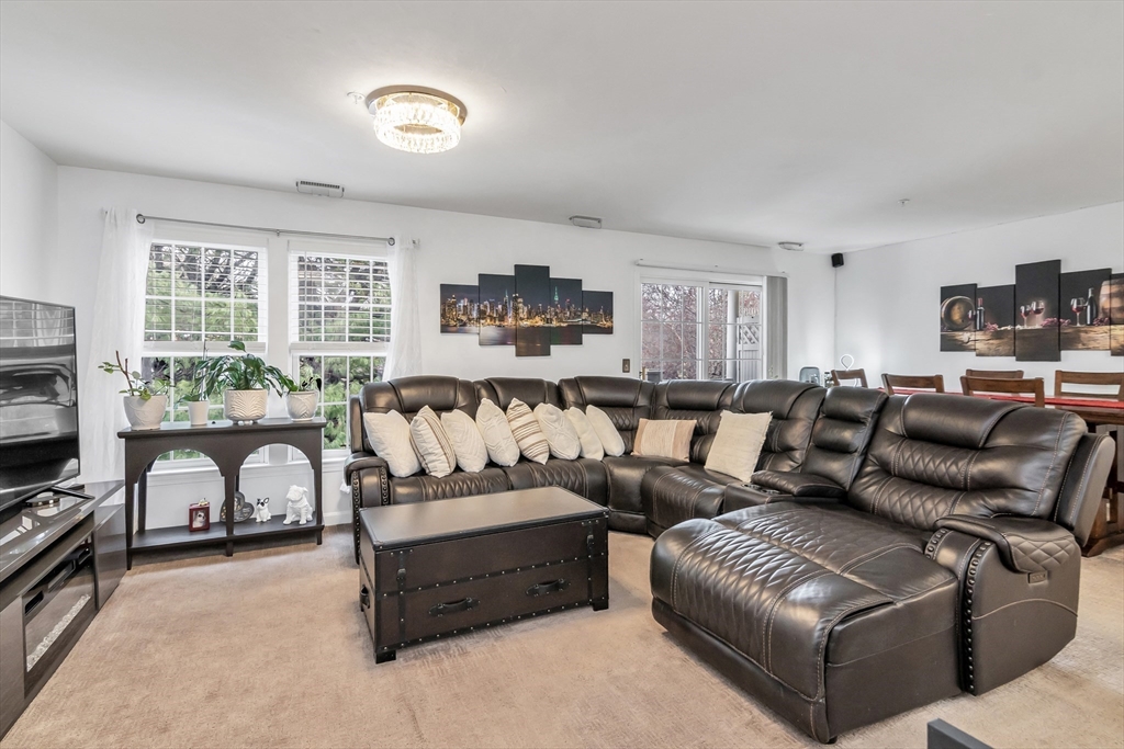 1 Riverview Boulevard, Unit 7204 Methuen, MA 01844 - Photo 5 of 29 a living room with furniture ceiling fan and a window